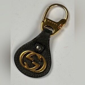 Gucci Black and Gold Logo Key Holder. Bag charm